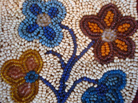 Native American Indian beadwork, a beautiful beaded pouch on native-tanned hide, Woodlands Indian, c. 1910-20. The beads are very fine, and the beadwork is exceptional! Closeup photo of the front of the pouch.