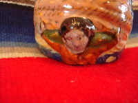 Mexican vintage pottery and ceramics, a beautiful pottery holy-water bottle in the image of Our Lady of Guadalupe, Tlaquepaque c. 1940. Photo of the angel at the base of the bottle.