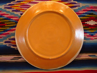 Mexican vintage pottery and ceramics, a very fine pottery plate featuring a leaping wolf, a blue bunny, butterflies and lovely foliage, with a starry-night background, from Tlaquepaque, Jalisco, c. 1920's. View of the back of the plate.