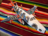 Mexican vintage folk art, and Mexican vintage pottery and ceramics, an amazing pottery jumbo jet with 13 very happy passengers, signed under one wing by the famous folk artist, Candelario Medrano, Santa Cruz de las Huertas, Jalisco, c. 1960's.  Main photo of the Medrano pottery airliner.