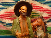Mexican vintage folk art, and Mexican vintage pottery and ceramics, a wonderful pottery figure of a Mexican paisano and his trusty quarter-horse, leaning against a tree stump, originally meant to be an ash tray, Tlaquepaque or Tonala, Jalisco, c. 1930's. Closeup photo of the man's face on the Tlaquepaque pottery piece.