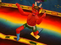 Mexican vintage folk art, and Mexican vintage woodcarvings and masks, a folk art woodcarving depicting an animated red devil with a lucha libre -like stance, signed Isaias Jimenez, son of the famous Manuel Jimenez of Oaxaca, c. 1960. Another full frontal view of the figure.