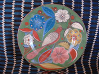 Mexican vintage pottery and ceramics, a beautiful burnished charger with an avocado-green background and phenomenal artwork featuring wonderful floral decorations with a tropical bird in the center, Tonala or San Pedro Tlaquepaque, c. 1930's. Main photo of the charger.