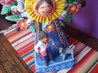 Mexican vintage folk art, and Mexican vintage pottery and ceramics, a wonderful pottery ferris wheel filled with happy people and very colorful decorations, Ocumicho, Michoacan, c. 1980's. Closeup photo of the figures at the front, under the ferris wheel.