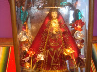 Mexican vintage devotional art, a beautiful statue of Our Lady of the Soledad, the patroness of Oaxaca, in a wonderful tin and glass nicho, c. 1950's. Closeup photo of Our Lady inside the nicho.