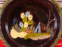 Mexican vintage pottery and ceramics, a blackware plate with wonderful artwork from Tlaquepaque, Jalisco, c. 1930-40's. The plate has a beautiful border and a scene of a lovely house amidst plants and cacti. This is the third Tlaquepaque plate of three, all probably by the same great artist. Photo of the central scene on the front of the plate.