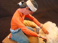 Native American Indian folk-art and wood-carving, a Navajo folk-art wood-carving of a Navajo man shearing his sheep, signed by the artist, c. 1970. Closeup photo of the Navajo carving.