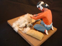 Native American Indian folk-art and wood-carving, a Navajo folk-art wood-carving of a Navajo man shearing his sheep, signed by the artist, c. 1970. Photo of the back of the folk-art carving.