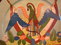Mexican vintage pottery and ceramics, a magnificent and extremely large charger featuring the Mexican national symbol, an eagle with snake in mouth and two Mexican flags, Tonala or Tlaquepaque, Jalisco, c. 1920-30's. Closeup photo of the eagle on the front of the charger.
