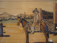 Mexican vintage straw art (popote art, or popotillo), a wonderful scene, composed using thousands of pieces of minute dyed straw (popote, in Spanish), showing a Mexican charro on his faithful and beautiful horse, c. 1940's. Closeup photo of the charro.