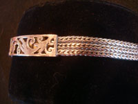 Mexican vintage sterling silver jewelry, and Taxco vintage silver jewelry, a lovely sterling silver bracelet with a repousee centerpiece, and braided silver bands on either side, Taxco, c. 1940-50's.  Side view of the Taxco silver jewelry bracelet.
