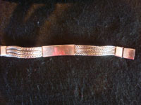 Mexican vintage sterling silver jewelry, and Taxco vintage silver jewelry, a lovely sterling silver bracelet with a repousee centerpiece, and braided silver bands on either side, Taxco, c. 1940-50's.  Photo showing the back side of the Taxco silver jewelry bracelet.