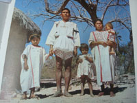 Mexican vintage textiles and serapes (sarapes), and blouses and huipiles, a cotton shirt and pants set with extraordinarily fine embroidery, Santa Maria Zacatepec, Oaxaca, 1950's. Photo from a publication showing a family in the traditional clothing.