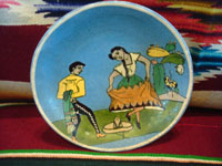 AE-1: Mexican vintage pottery and ceramics, a tea-cup and saucer with incredibly fine artwork, featuring a lovely Charra, dressed in her China Poblana costume, doing the famous dance, El Jarabe Tapatio, Tlaquepaque or Tonala, Jalisco, c. 1930. Closeup photo of the front of the saucer.