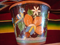 Mexican vintage pottery and ceramics, a pair of planters, very early and with exquisite artwork, Tlaquepaque or Tonala, Jalisco, c. 1920-30's. The scenes decorating these planters are incredible, with verdant plants, burros, birds, and animals, including graceful deer. A side view of one of the planters, showing a lovely bird amidst foliage.