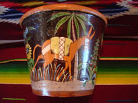Mexican vintage pottery and ceramics, a pair of planters, very early and with exquisite artwork, Tlaquepaque or Tonala, Jalisco, c. 1920-30's. The scenes decorating these planters are incredible, with verdant plants, burros, birds, and animals, including graceful deer. A side view of one of the planters, showing a wonderful burro under a graceful palm tree.