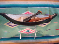 Native American Indian vintage folk art and woodcarving, a graceful and lovely model Nootka boat with oars, West Coast of Vancouver Island, British Columbia, c. 1960's. Photo from above looking down at the boat and oars.