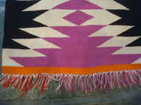 Native American Indian vintage textiles, and Navajo vintage rugs and textiles, a beautiful Navajo rug of fine Germantown woolen yarn, Arizona or New Mexico, c. 1900. A photo of one edge of the Navajo rug showing the fringe.
