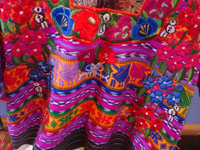 Guatemalan vintage textiles and huipiles, a beautiful Guatemalan huipil from Totonicapan with wonderful embroidered flowers around the yoke, c. 1980. Closeup photo showing the embroidery near the yoke of the huipil.