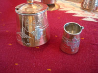 Mexican vintage copper and silver jewelry, an elegant and beautiful tea/coffee set of copper with sterling silver decorative scenes on each piece, signed Victoria, Taxco, c. 1940's. Closeup photo of two other pieces, including the cream pitcher.