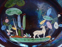 Mexican vintage pottery and ceramics, a lovely blackware pottery plate decorated with a wonderful deer, grazing amidst beautiful cacti, Tonala or San Pedro Tlaquepaque, c. 1930's. Closeup photo of the front of the plate.