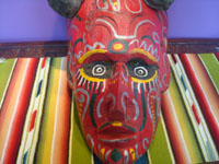 Mexican vintage woodcarvings and masks, a wonderful wooden mask depicting a devil and used in ceremonial dances, Guerrero, c. 1940's. A closeup photo of the front of the mask.