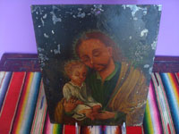 Mexican vintage devotional art, a retablo painted on tin depicting St. Joseph with the baby Jesus, c. 1920.  Front view of the entire retablo.