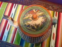 Mexican vintage pottery and ceramics, a beautiful petatillo (background cross-hatching resembling a straw mat or petate) tea pot with beautiful decorations. Tonala or San Pedro Tlaquepaque, c. 1930's. Photo shot from above the tea pot, looking down at the lid.