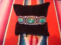 Native American Indian sterling silver jewelry, and Navajo vintage sterling silver jewelry, a beautiful Fred Harvey silver bracelet with wonderful stamping and lovely turquoise stones each showing a beautiful matrix, Arizona or New Mexico, c. 1930's. Main photo of the bracelet.