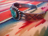 Native American Indian sterling silver jewelry, and Navajo vintage sterling silver jewelry, a beautiful Fred Harvey silver bracelet with wonderful stamping and lovely turquoise stones each showing a beautiful matrix, Arizona or New Mexico, c. 1930's. Side view of the bracelet showing the stamping.