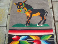 Mexican vintage sarapes and textiles, a lovely Oaxacan woolen textile featuring a wonderful donkey, Oaxaca, c. 1950's. Closeup photo of the front of the textile showing the donkey.