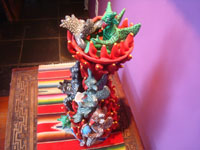 Mexican vintage folk art, and Mexican vintage pottery and ceramics, a beautiful pottery sculpture of a burning tower of devils delighted by the tasty fowl being roasted in a bowl on the top, Ocumicho, Michoacan, c. 1950. View of the bottom part of the sculpture.