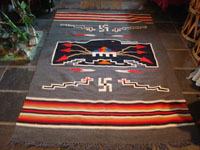 New Mexican vintage textile, a finely woven rug from the weaving center of Chimayo, New Mexico, c. 1930. This is from a very famous weaver, active from 1910-40, whose signature was the hummingbird in the center of this textile. Main photo.
