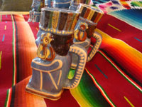 Mexican vintage pottery and ceramics, a pulque or punch set with pitcher and 5 mugs in the form of Aztec gods, c. 1940. Wonderful blue glaze with hand-painted faces and decorations on each piece. Photo of back of pitcher.