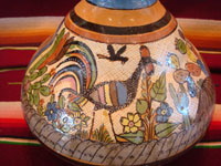 Mexican vintage pottery and ceramics, a water jar attributed to the great Balbino Lucano, Tlaquepaque, Jalisco, c. 1920-30's. The jar is done in the petatillo hatchwork style (with straw-like hatchwork in the background) for which Balbino Lucano is famous. Closeup photo of the wonderful artwork on one side of the Tlaquepaque pottery jar.
