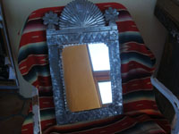 Mexican vintage tinwork art (tin art), a beautiful tinwork art mirror with a lovely form and very good stamping, c. 1940's. The shape of the mirror reflects the form of the facade of a church. Main photo of the tin art mirror.