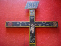 Mexican vintage devotional art, and Mexican vintage woodcarvings and masks, a beautiful wooden Animas Cross, decorated with the image of the Crucified Christ and adorned with an array of religious images, Queretaro, c. late 19th century. Closeup photo of the center of the cross.