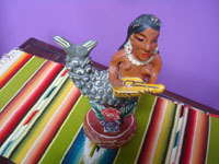 Mexican vintage folk art, a pottery figure of a mermaid joyfully playing her guitar, Ocumicho, Michoacan, c. 1960's. A side view of the mermaid.
