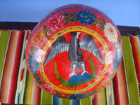 Mexican vintage folk art, a beautifully decorated "jicara" (gourd) used for drinking champurrada or horchata (two popular beverages made of milk, rice, and cinnamon), Puebla, c. 1950's.  Photo of the outside of the gourd showing the eagle.