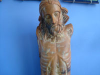 Mexican vintage devotional art, a carved wooden figure depicting the corpus of Christ, c. mid-19th century.  Closeup photo of Jesus's face.
