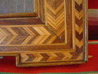 Mexican vintage wood-carving and Mexican vintage folk art, a wonderful marquetry picture frame, c. 1930. Beautifully hand-crafted with inlays of different kinds of wood. Closeup photo.