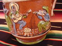 Mexican vintage pottery and ceramics, a wonderful pottery pulque pitcher from Tlaquepaque, Jalisco, c. 1930's. Closeup of the musicians on the pitcher.