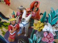 Mexican vintage folk art, and Mexican vintage pottery and ceramics, a very colorful and wonderful pottery piece depicting the Flight Into Egypt of the Holy Family, Ocumicho, Michoacan, c. 1960's. A side view of the piece.