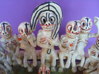 Mexican vintage folk art, a wonderful pottery piece depicting a gathering of souls or skeletons, perhaps Christ and the Apostles, or some rite of passage, Ocumicho, Michoacan, c. 1950's. Closeup photo of the figure at the center-back of the group.