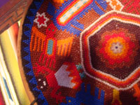 Mexican vintage folk art, a Huichol beaded gourd with very fine and intricate decorations in the beadwork, Jalisco or Nayarit, c. 1980's. Closeup photo of the beadwork.