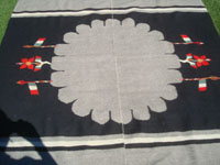 Vintage Mexican textiles and sarapes, a beautiful Oaxacan textile with naturally colored black and white wool, and with patriotic symbols of the Mexican flag, Oaxaca, c. 1940's.  Closeup photo of the center showing the Mexican flags.