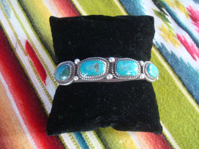 Native American Indian sterling silver jewelry, and Navajo sterling silver jewelry, a beautiful Navajo bracelet of sterling silver with four wonderful turquoise stones, with a twisted wire bezzle and bumpouts, Arizona or New Mexico, c. 1960's.