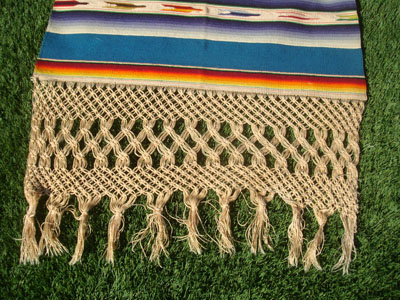 Mexican vintage textiles and Saltillo-style serapes (sarapes), a magnificent Saltillo-style serape runner, very finely woven and with lovely teneriffe (lacework) between the colorful bands of the textile, c. 1940's. This textile runner is a true work of art! Closeup photo showing the wonderful fringe at one end.