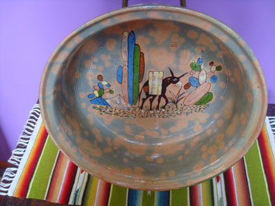 Mexican vintage pottery and ceramics, a large Tlaquepaque pottery bowl with wonderful artwork including a burro with a heavy load of sugar cane amidst lovely cacti, Tonala or Tlaquepaque, Jalisco, c. 1940's.