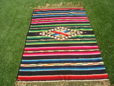 Mexican vintage textiles and Saltillo serapes (sarapes), a very beautiful Saltillo-stlyle serape with a wonderful center medallion and beautiful colors against a black background, c. 1940's.